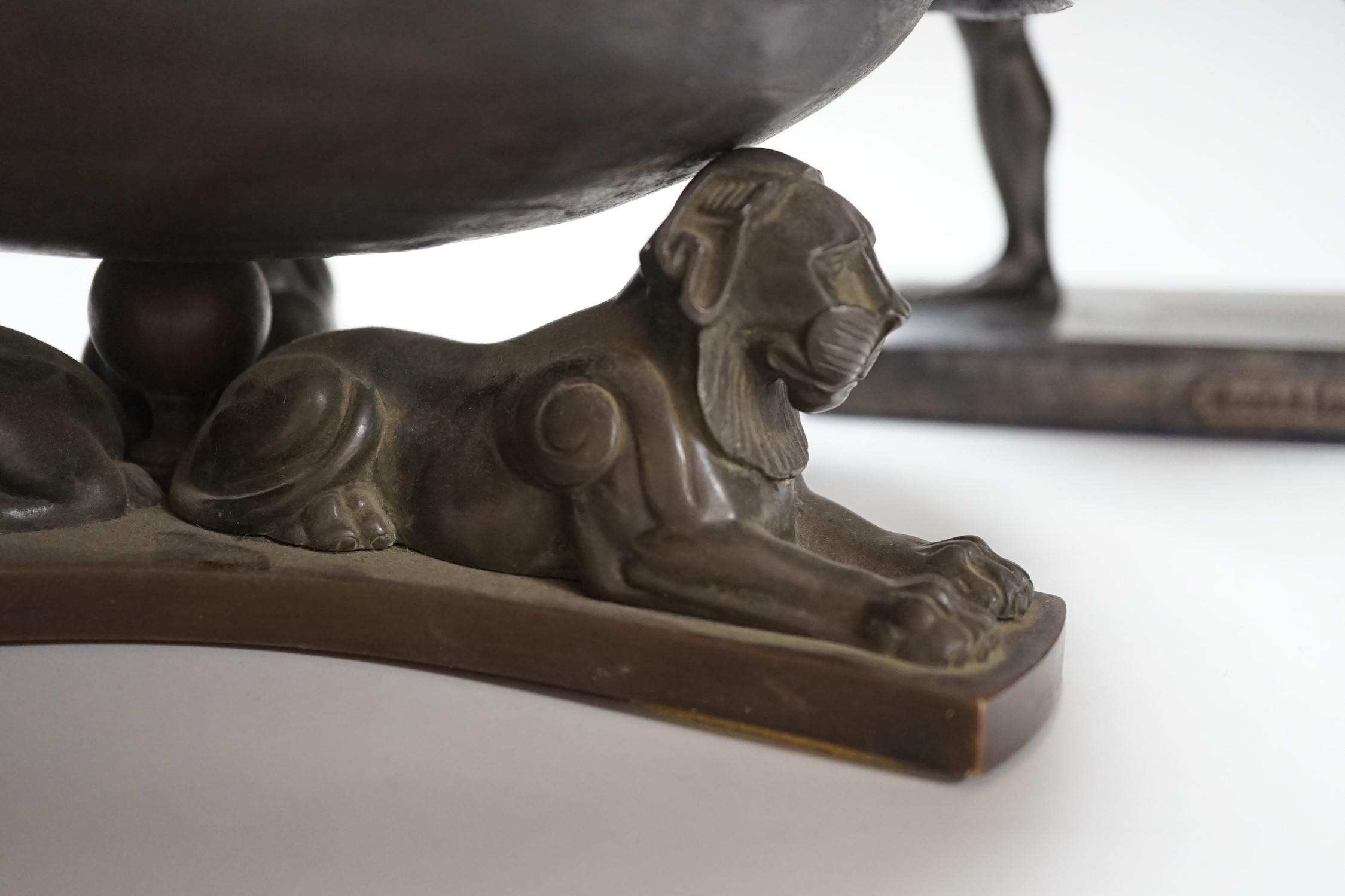 A large bronze dish, on triform lion base, and a bronze-finished warrior, dish 28cms diameter